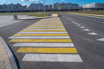 Open space with road signs and road markings, road intersections, pedestrian crossings, sunny day, blue sky, city landscape background