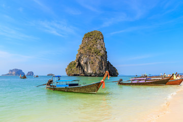 Fototapeta na wymiar Beautiful clear turquoise blue sea and boats at Ao Phra Nang near Railay beach, Krabi, Thailand
