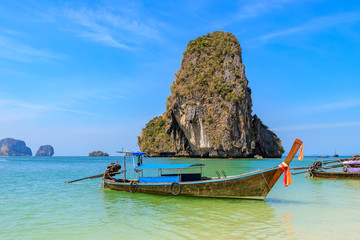 Obraz na płótnie Canvas Beautiful clear turquoise blue sea and boats at Ao Phra Nang near Railay beach, Krabi, Thailand