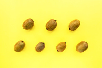 Kiwi fruits on a yellow background