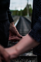 the couple holding hands at the railway - 268390078