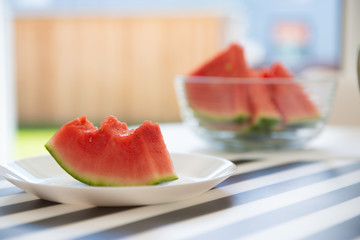 A slice of juicy red watermelon in white plate