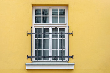 Window on yellow wall.