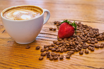 Delicious latte coffee and red strawberry