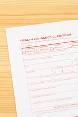 Health insurance claim form on wooden desk