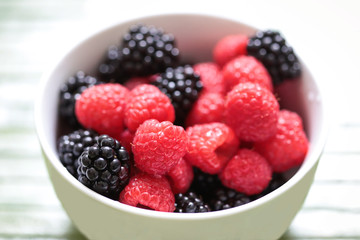 Raspberries and blackberries in a bowl