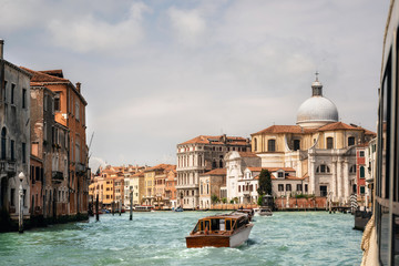 Speed boat floats across Canal Grande against View on Chiesa di San Geremia, Venice, Italy. View from vaporetto