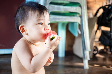 Cute Asian baby girl eating watermelon, Female kid enjoy eating watermelon  