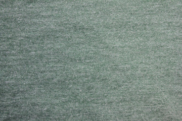 Faded mint green color fabric texture. Top view of cotton green shirt material 