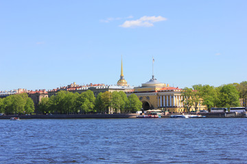 Fototapeta na wymiar Admiralteyskaya embankment with Admiralty building on summer day view across Neva river water 
