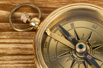Compass on wooden background, concept for direction transportation and travel