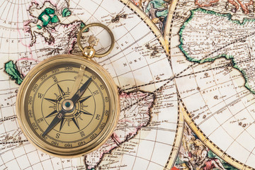Fototapeta na wymiar Compass on vintage ancient map, concept for direction transportation and travel
