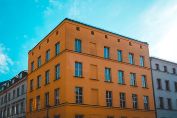 Fototapeta na wymiar orange corner house at berlin with blue sky on the top