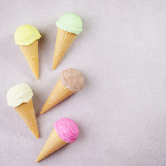 Set of various ice cream scoops in waffle cones. Food background, refreshment, rainbow, variety, cool seasonal sweets, refreshment concept