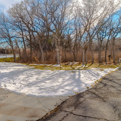 Clear Square Table and benches at a snowy picnic area near a lake on a sunny winter day