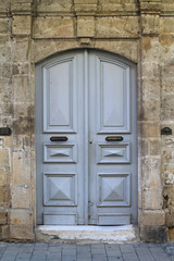 Wooden front door in old stone wall