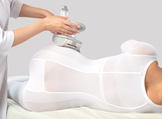 The masseur make an  hardware anti-cellulite lpg massage in a beauty salon.