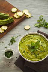 Fresh vegan plate of zucchini cream soup