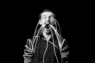 a man in a shirt wrapped the wires, the wires go out of his mouth