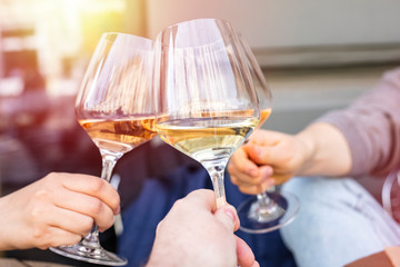 Clinking glasses with white wine and toasting. Three glasses of wine close up. Copy space