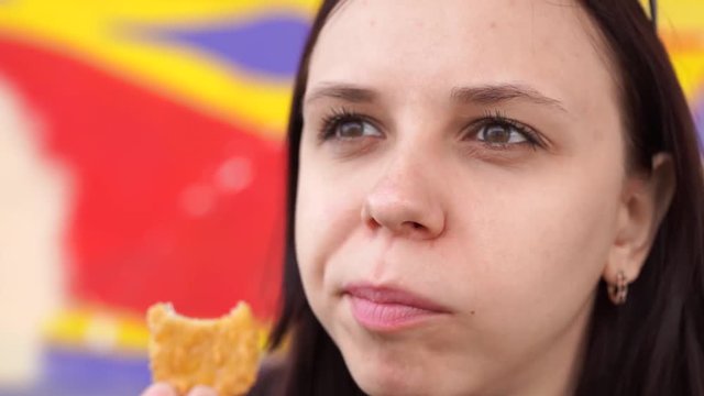 Woman eats chicken nuggets, harmful and tasty fast food, close up