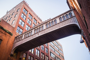 Gateway bridge between two red brick buildings in Chelsea - New York City, NY