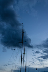 Yacht mast with the evening sky and moon - Image