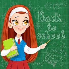 Back to school - cute red haired teenager girl with a textbook at the  blackboard