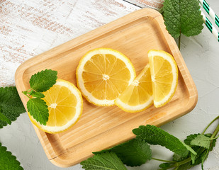 sliced yellow juicy lemon slices  and green fresh mint leaves