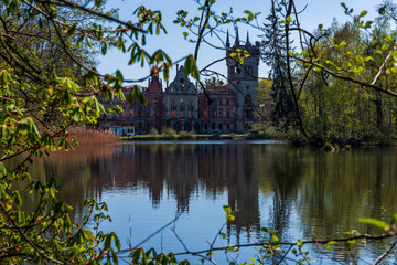 Water castle Koppitz in Poland. The castle ruin from the garden side