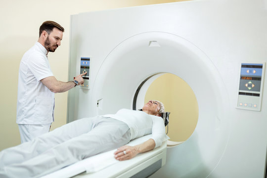 Radiologist and a patient during CT scan examination in the hospital.