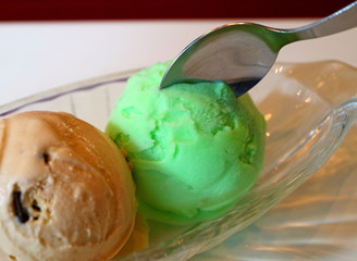 Closeup a Spoon Scooping Up Lime Sherbet Ice Cream