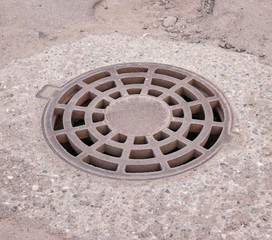 storm drain on the road iron grate
