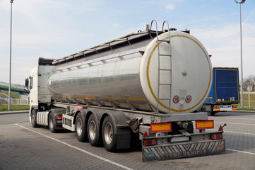 Naklejka na ściany i meble A truck with a tanker designed to transport food products. Long vehicle.