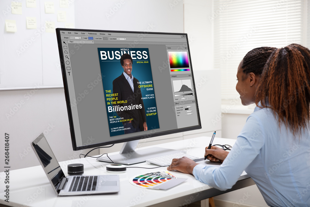 Poster designer editing photos on computer