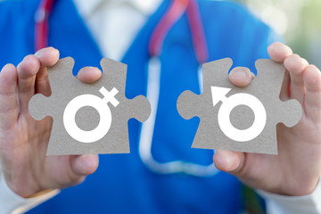 STD Sexually Transmitted Diseases Health concept. Doctor holds a two puzzle pieces with gender symbols. © wladimir1804