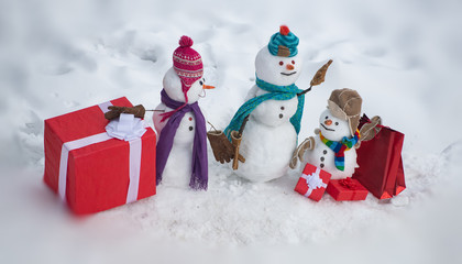 Christmas holidays discounts and winter sale. Greeting snowman. Winter snowman family. Mother snow-woman, father snow-man and kid wishes merry Christmas and Happy New Year.