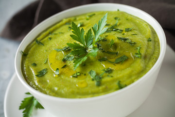 Fresh vegan plate of zucchini cream soup