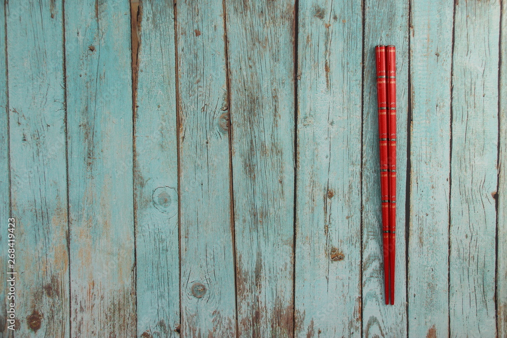 Wall mural Baguettes rouge sur une table en bois