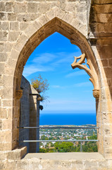 Amazing window view from the ruins of historical Bellapais Abbey in Cypriot Kyrenia region. The beautiful monastery is overlooking the Mediterranean in Turkish part of Cyprus. Taken in late summer