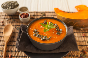 Fresh vegan plate of pumpkin cream soup