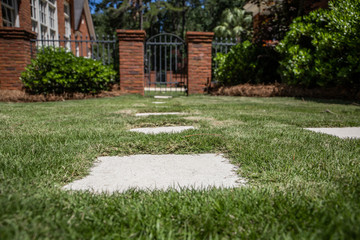 Patterned Square Design Concrete Sidewalk Walkway Pathway on Lawn