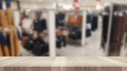 Empty wood table and blurred clothing store, product display montage