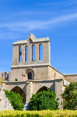 Fototapeta na wymiar Medieval Bellapais Abbey in Turkish Northern Cyprus captured on vertical picture with blue sky. Beautiful historical site and popular Cypriot tourist attraction