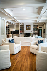 Large Living Room Den in Home with Vaulted Tray Ceiling and bookshelves