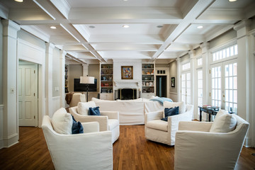 Large Living Room Den in Home with Vaulted Tray Ceiling and bookshelves