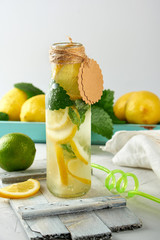 soft drink lemonade in a glass bottle and ripe fresh lemons