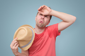 Man is worried and tired because of sweating stain