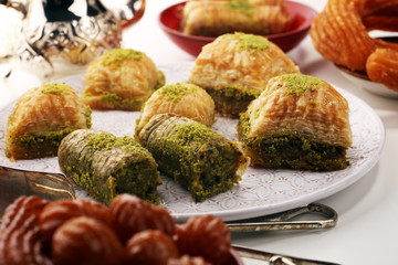 Middle eastern or arabic dishes. Turkish Dessert Baklava with pistachio on dishes