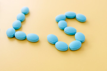 English letters L and S blue tablets on yellow background. The inscription on the plates. A message, a personal concept.